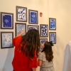 Education Director Pamela Cevallos and a West Wortham student go over the childrens' art together.