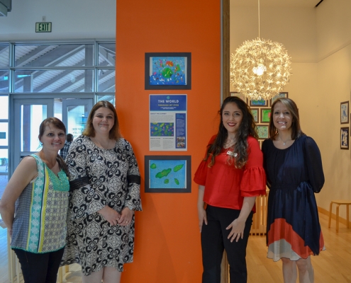 Teachers from West Wortham pose in front of The World Through My Eyes Gallery