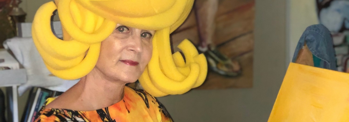Paulette Dove paints in yellow costume
